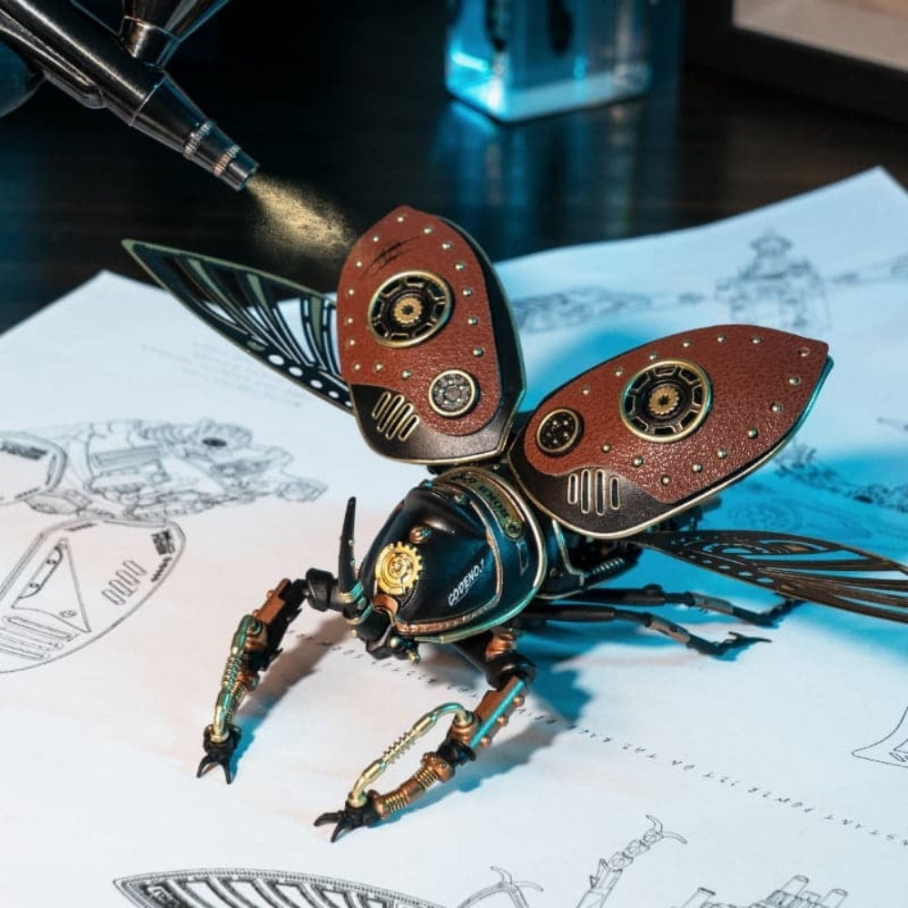 Steampunk-style beetle figurine on technical drawings