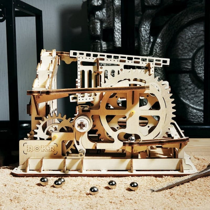 Wooden mechanical model with gears on a wooden surface