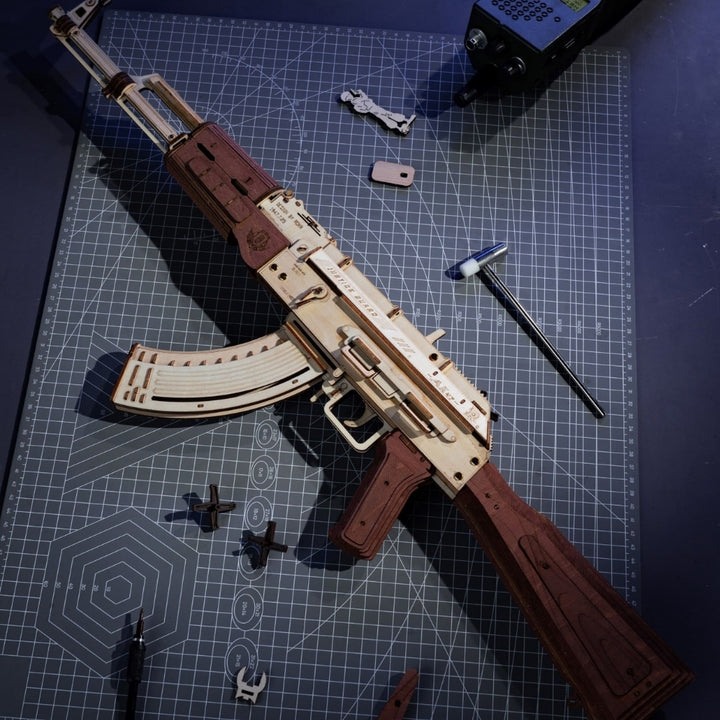 Wooden model of a rifle on a cutting mat with tools