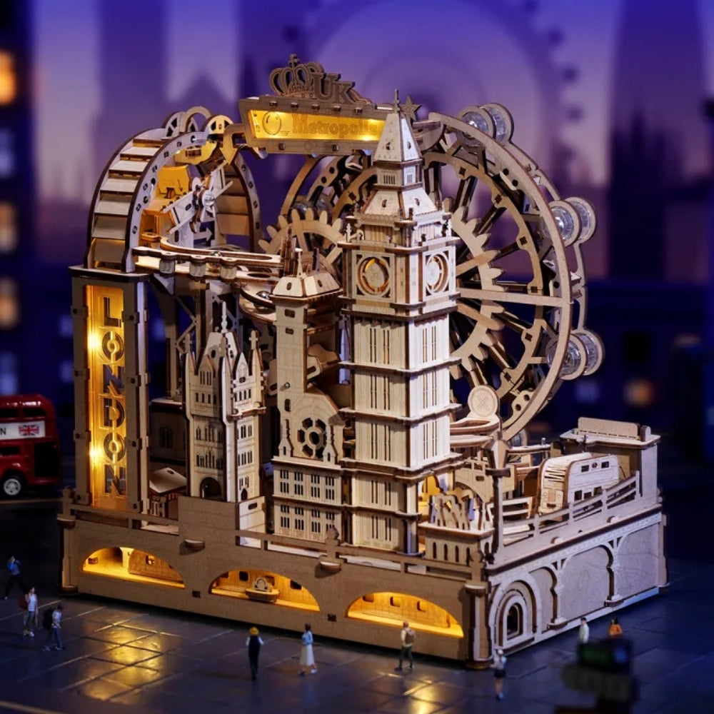 Wooden model of a clock tower with mechanical gears and lights, set against a blurred cityscape background.