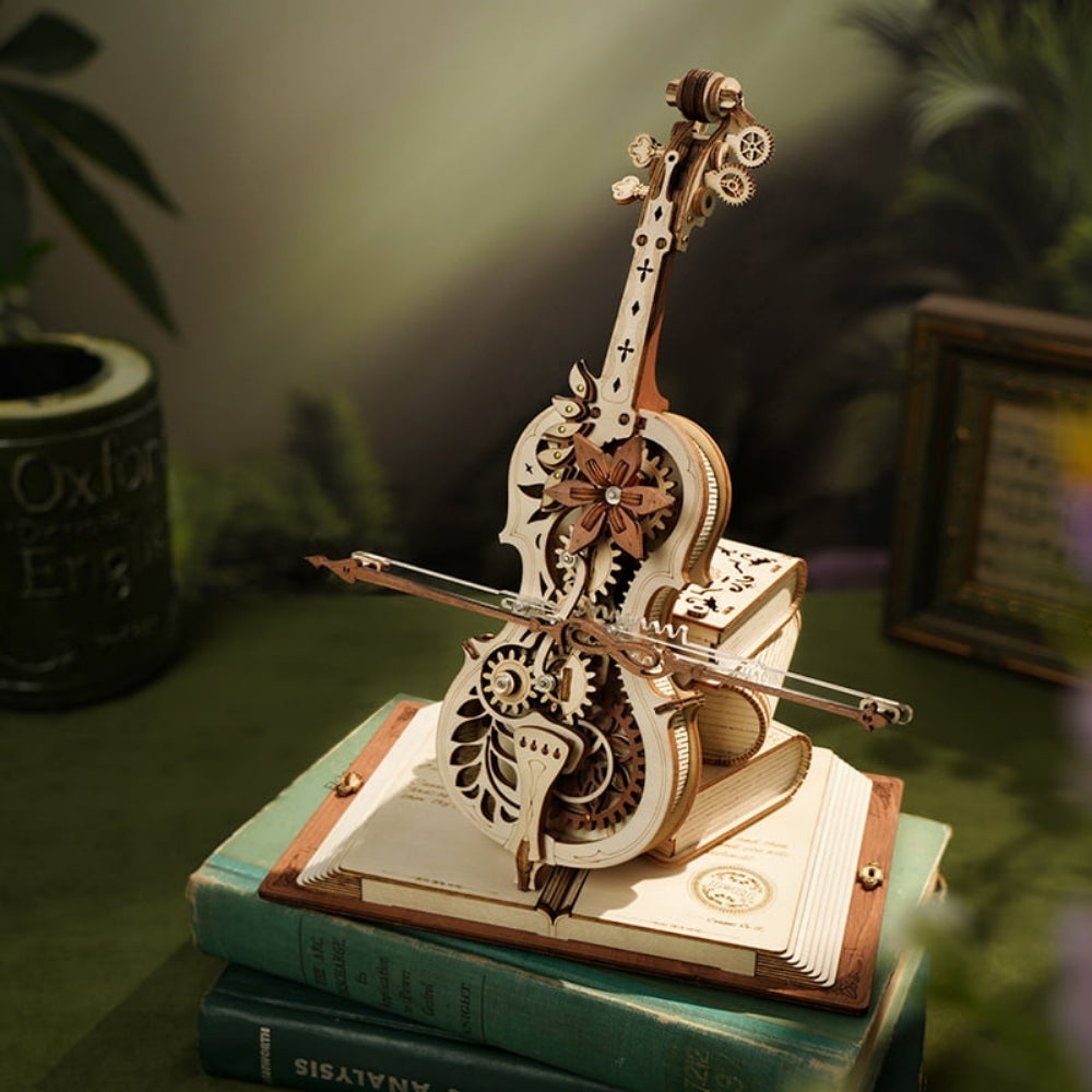 Mechanical model of a cello on top of books with a blurred background
