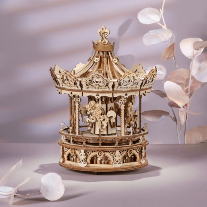 Wooden carousel model on a neutral background with decorative elements