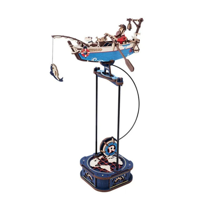 Decorative spinning toy with a boat and figures on a white background