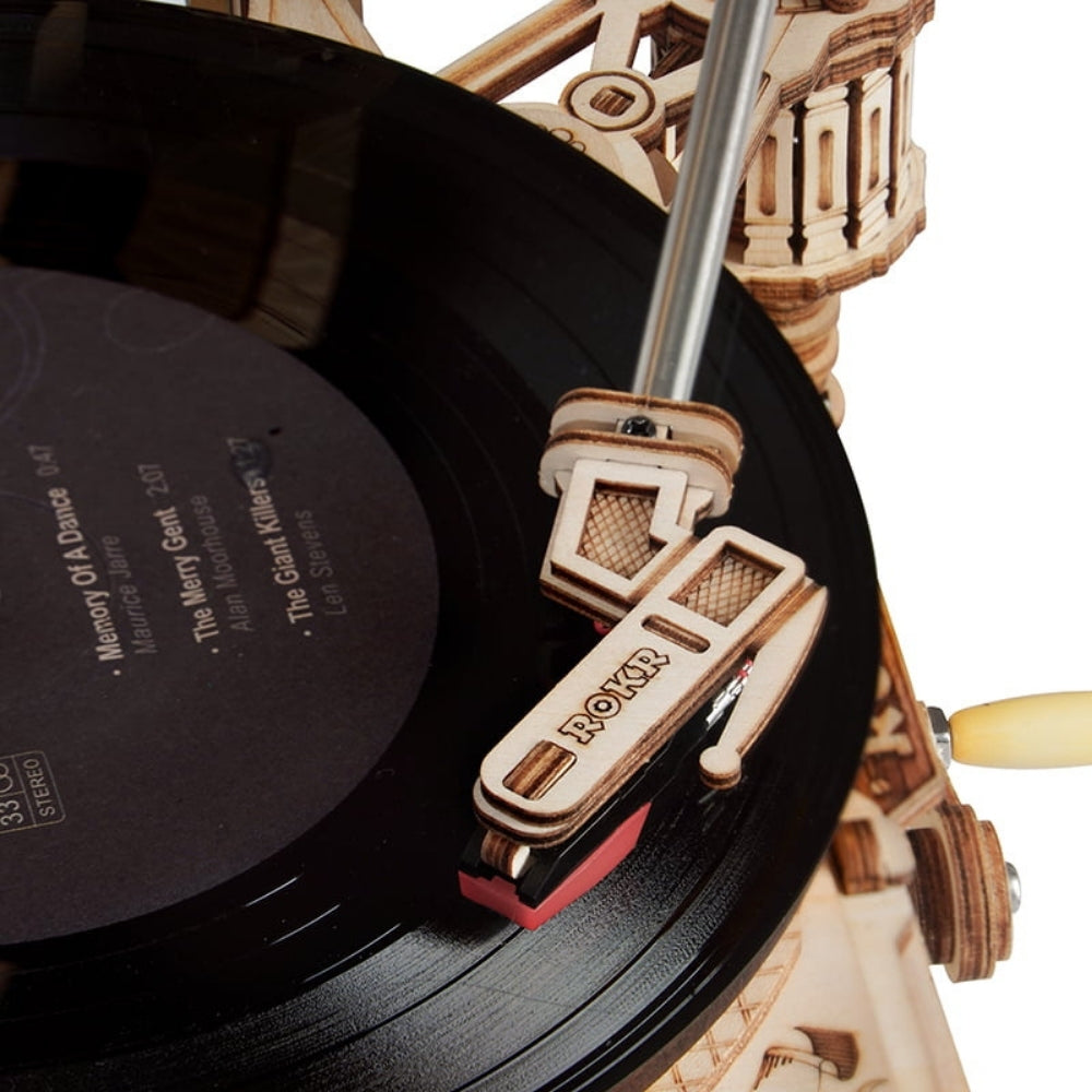 Record player with a record and a Boker knife on top, set against a white background.