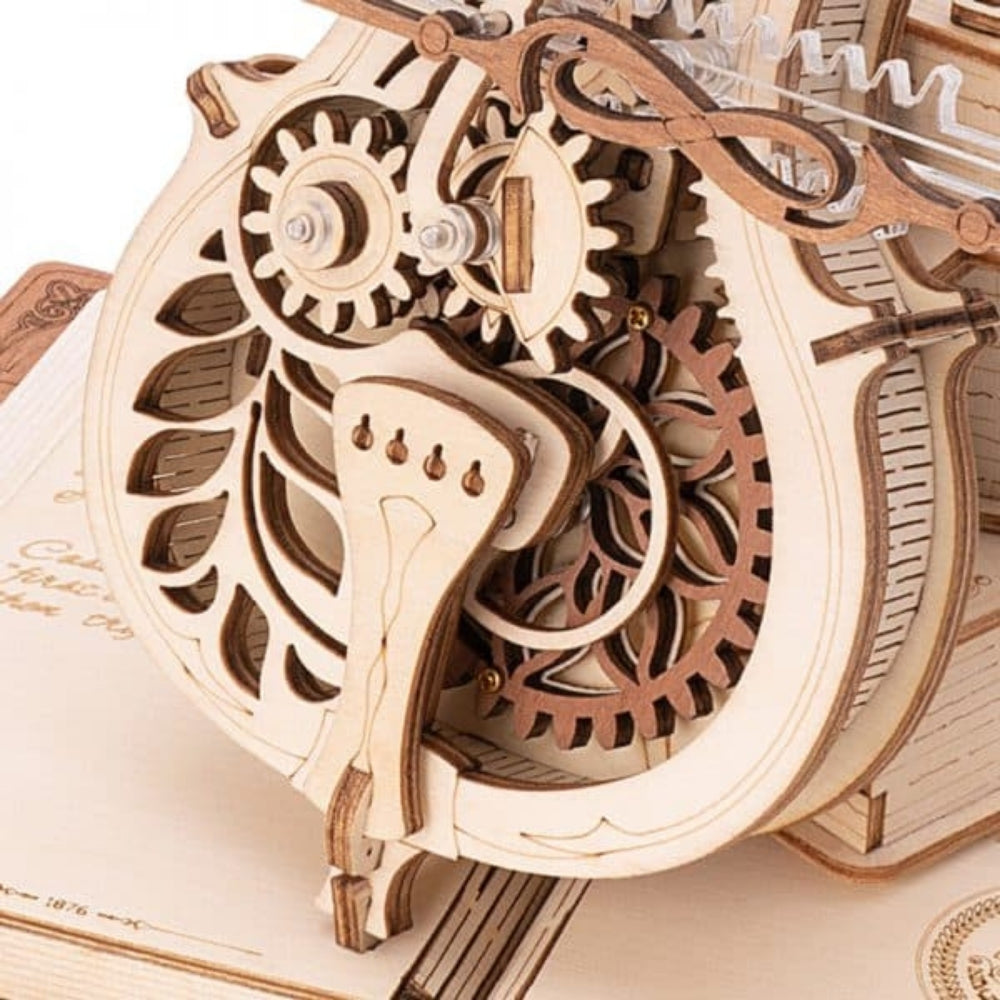 Wooden mechanical model with gears on an open book