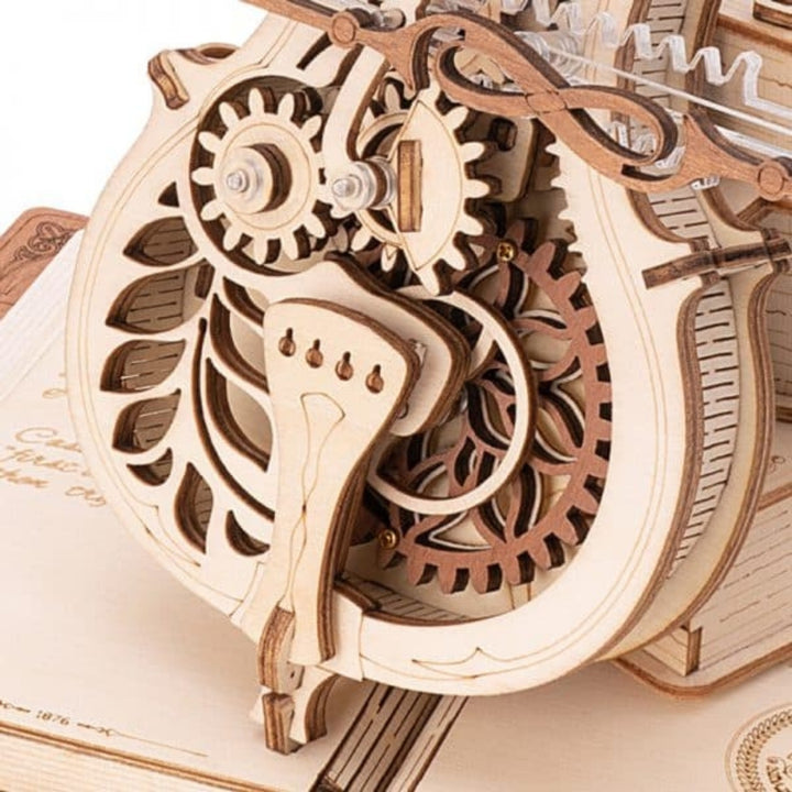 Wooden mechanical model with gears on an open book