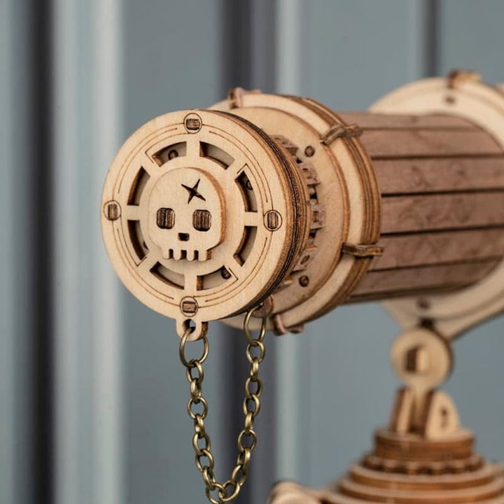 Wooden mechanical model with chain against a gray background