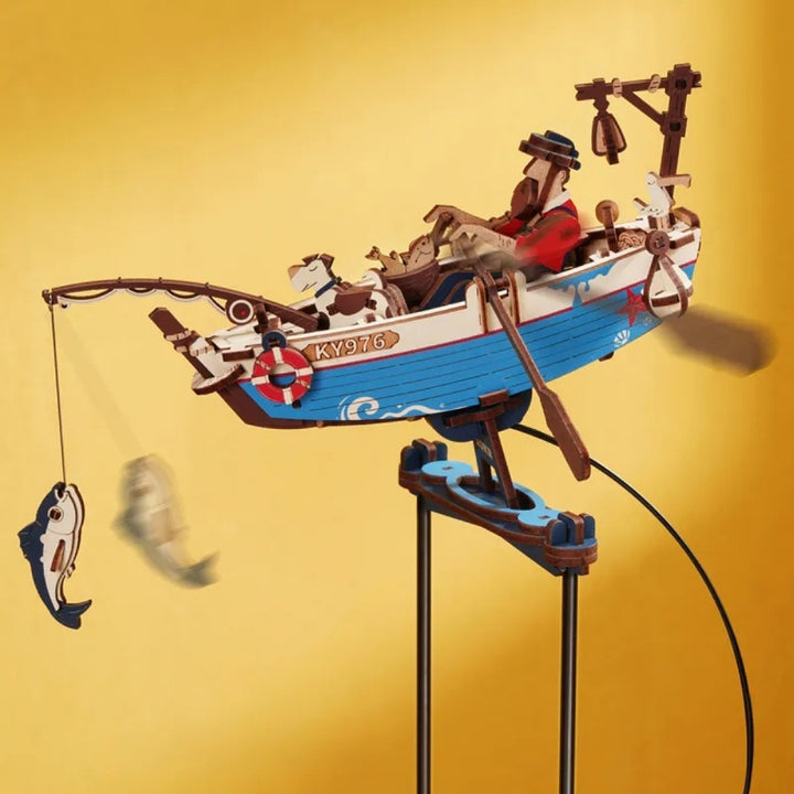 Toy boat with figures on a stand against a yellow background