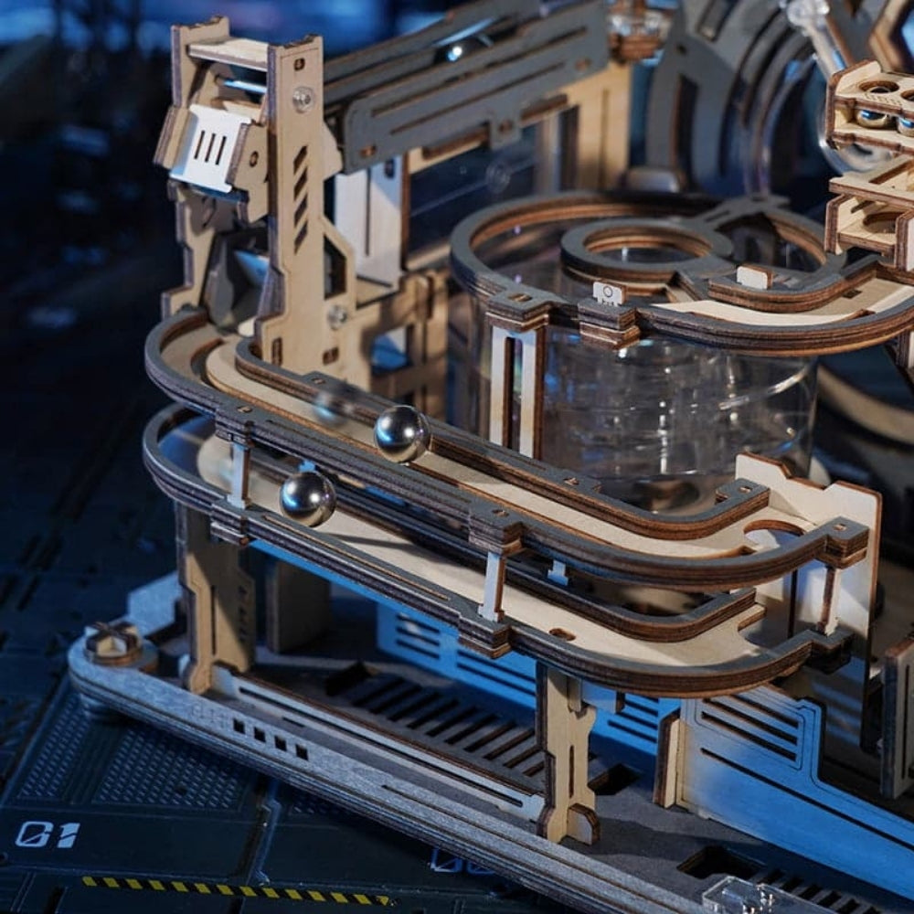 Close-up of a mechanical model with wooden and metal components on a dark background.