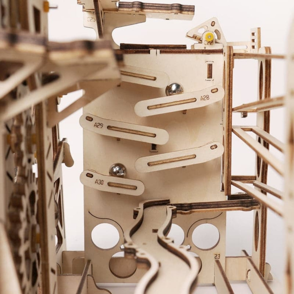 Wooden mechanical model with intricate details on a white background