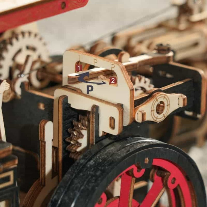 Close-up of a mechanical model with gears and wooden components.